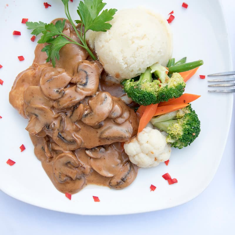 Chicken Marsala with mushroom sauce, rice and vegetables